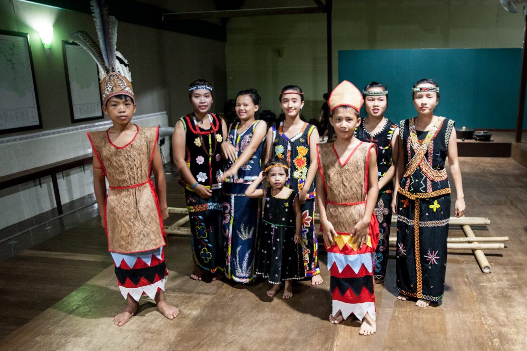 Murut people in traditional attire preparing for a cultural performance.